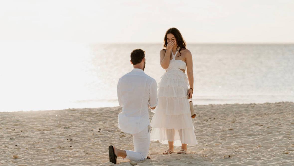 Seth proposing to Bailey on the beach at sunset