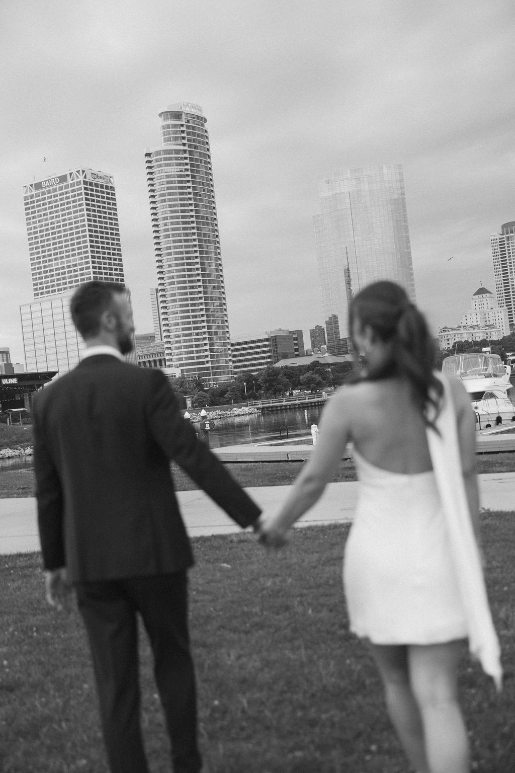 Bailey and Seth hand in hand looking out at the Milwaukee skyline