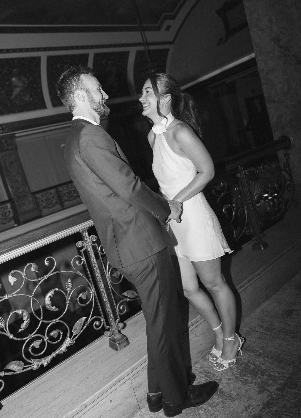 Bailey and Seth holding hands on a grand staircase